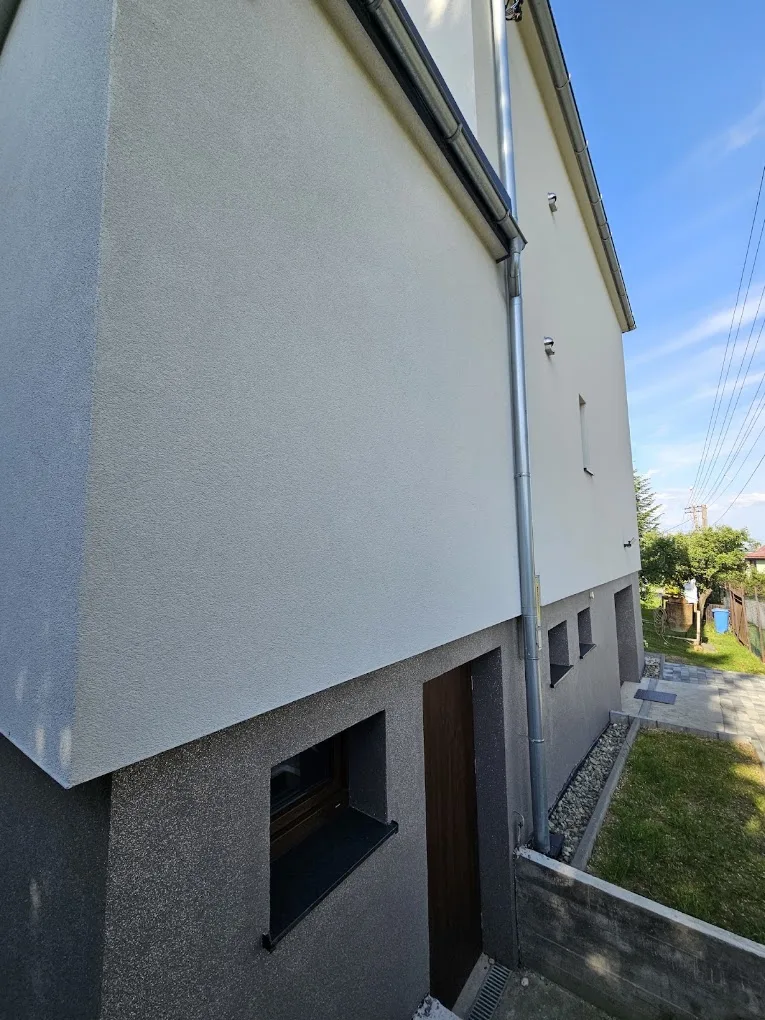 Elewacja domu piętrowego wykończona w jasnych barwach